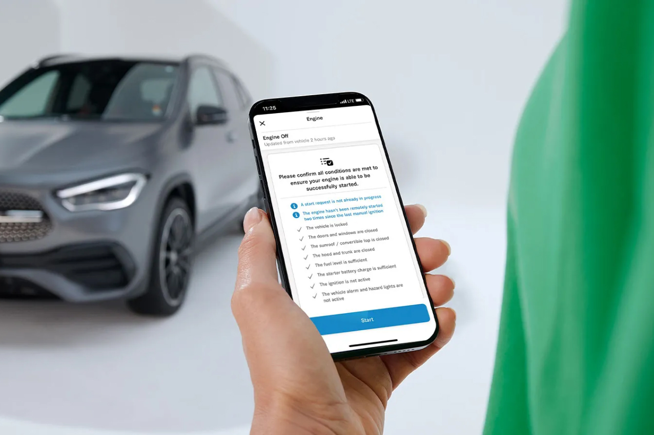 Hand holding a smartphone running the Mercedes-Benz app