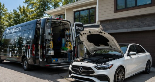 Mobile Service Unit with rear doors open servicing a Mercedes-Benz in a driveway