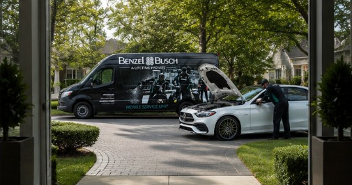 A Benzel-Busch technician performing on-site service on a Mercedes-Benz at a customer’s home